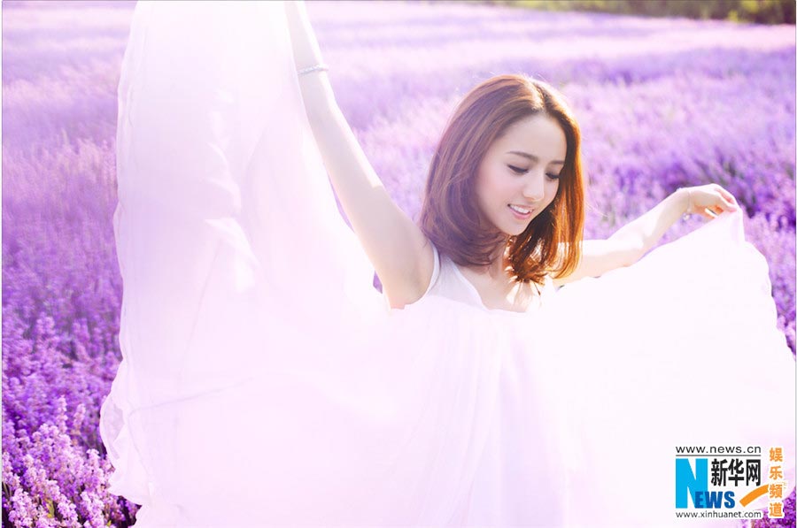 Tong Liya poses in blooming lavender flowers