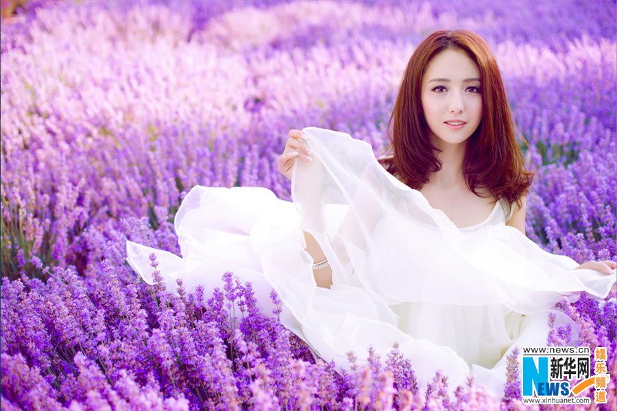 Tong Liya poses in blooming lavender flowers