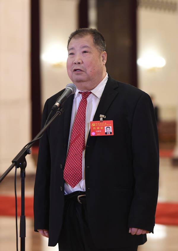 Delegates pick up questions at the Great Hall of the People