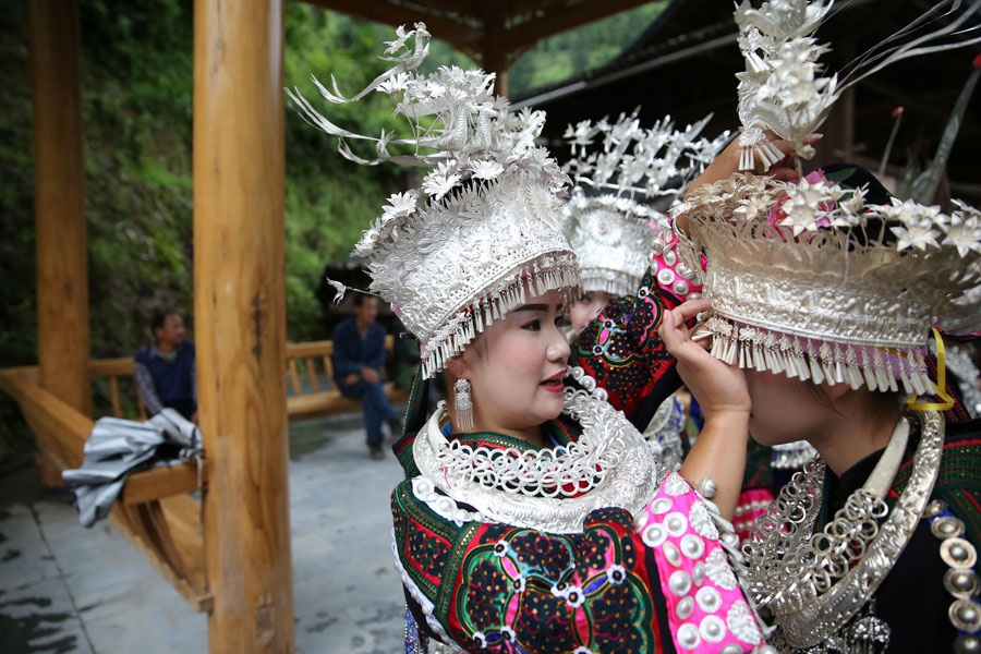 Miao people in traditional costume welcome experts in rural construction