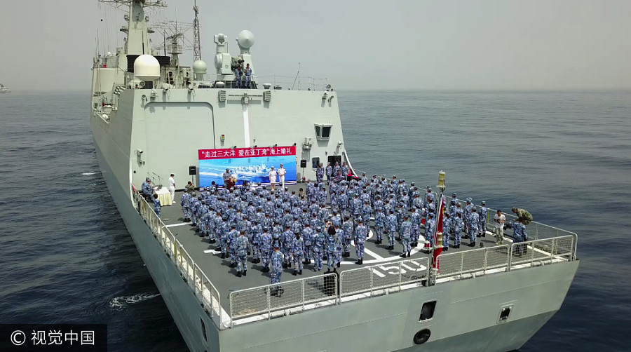 Navy sailors tie knot in middle of sea