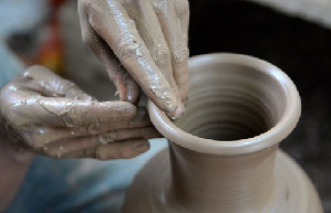 Purple clay pottery artisan follows dream