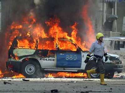 An Iraqi fireman runs next to a burning car, following an explosion near a police station in Rashid Street in central Baghdad, September 17, 2004. [Reuters]