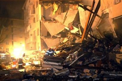 Rescue workers clear rubble and debris at the explosion site of a five-story apartment building, late Sunday, Dec. 26, 2004 in Mulhouse, eastern France. A gas explosion tore through the building Sunday afternoon, killing 15 people and injuring another 14. Rescue workers initially found two bodies Sunday, and discovered 13 more early Monday, Dec. 27 in the rubble. [AP]