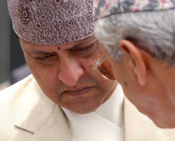 Nepal's King Gyanendra listens to one of his subjects in Gokarna, near Kathmandu in this May 17, 2004 file photo. Gyanendra sacked the government on February 1, 2005, announcing the decision in an address broadcast on state radio. Prime Minister Sher Bahadur Deuba had been reappointed last June, about two years after Gyanendra fired him for failing to tackle a long-standing revolt against the monarchy. [Reuters]