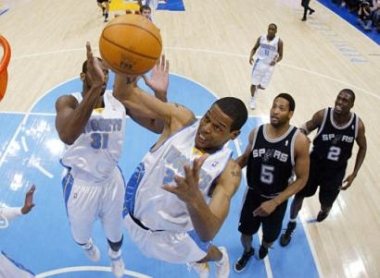 Denver Nuggets forward Marcus Camby, second from left, pulls in a rebound as Nuggets forward Nene, left, of Brazil looks on with San Antonio Spurs forward Robert Horry, third from left, and center Nazr Mohammed in the first quarter of Game 4 of the teams' NBA Western Conference first-round playoff series in Denver on Monday, May 2, 2005. (AP