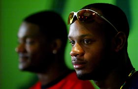 Asafa Powell (R) of Jamaica and Justin Gatlin of the U.S. address a news conference for the presentation of the 25th Golden Gala athletics meeting in Rome July 7, 2005. The international meeting will be at the Olympic Stadium in Rome on Friday.