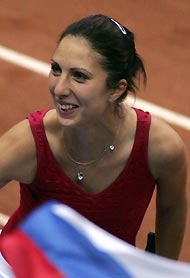 Russia's Anastasia Myskina smiles as she celebrates her victory over Jill Craybas of the U.S. during their Fed Cup semi-final match at Olympiyskiy stadium in Moscow, July 10, 2005. Myskina won the match 6-2 6-4. 