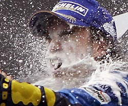 Renault's Formula One overall leader Fernando Alonso of Spain enjoys champagne after winning the German Formula One Grand Prix, his sixth victory in this year's Formula One season, at the Hockenheim race track, July 24, 2005. Alonso won the race ahead of William's Juan Pablo Montoya of Colombia and Honda's Jenson Button of Great Britain. 