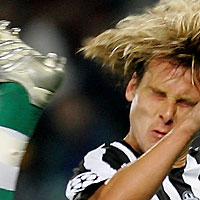 Juventus's Pavel Nedved (R) is tackled by SK Rapid Wien's Andreas Ivanschitz during their Champions League Group A soccer match at the Delle Alpi stadium in Turin September 27, 2005.