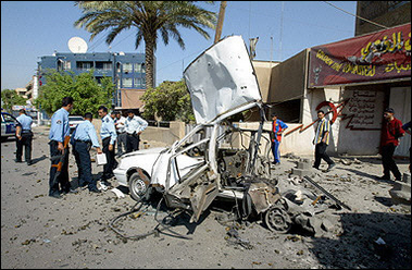 Iraqi policemen secure the site where a car bomb exploded in central Baghdad.