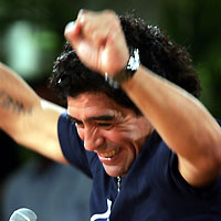 Diego Maradona (L) and Cuban President Fidel Castro smile after appearing together on a live television broadcast in Havana, October 27, 2005. Maradona was in Havana to interview Castro for his weekly television show in Argentina and promised President Castro he would be at the front of an anti-Bush march in Argentina next week.