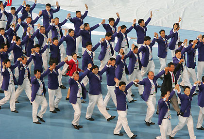 'North Korea's and South Korea's athletes enter the field holding hands during the opening ceremony of the 4th East Asian Games in Macau October 29, 2005. 