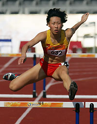 hina's Huang Xiaoxiao competes in the women's 400-metres hurdles final at the 4th East Asian Games in Macau November 2, 2005. Huang won the gold medal in the event. 