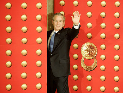 uU.S. President George W. Bush waves to the press as he leaves a news conference in Beijing November 20, 2005, where he had just tried to exit through a locked door.