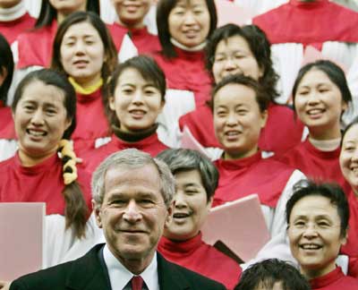 U.S. President George W. Bush smiles in front of a Chinese choir after attending a Sunday morning service at the Gangwashi Church in Beijing, November 20, 2005. 