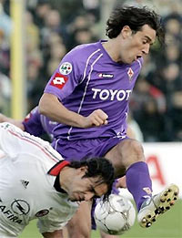 Fiorentina striker Luca Toni, right, and AC Milan defender Alessandro Nesta challenge for the ball during their Italian first division soccer match at the Artemio Franchi stadium in Florence, Italy, Sunday, Nov. 20, 2005. Fiorentina won 3-1. 