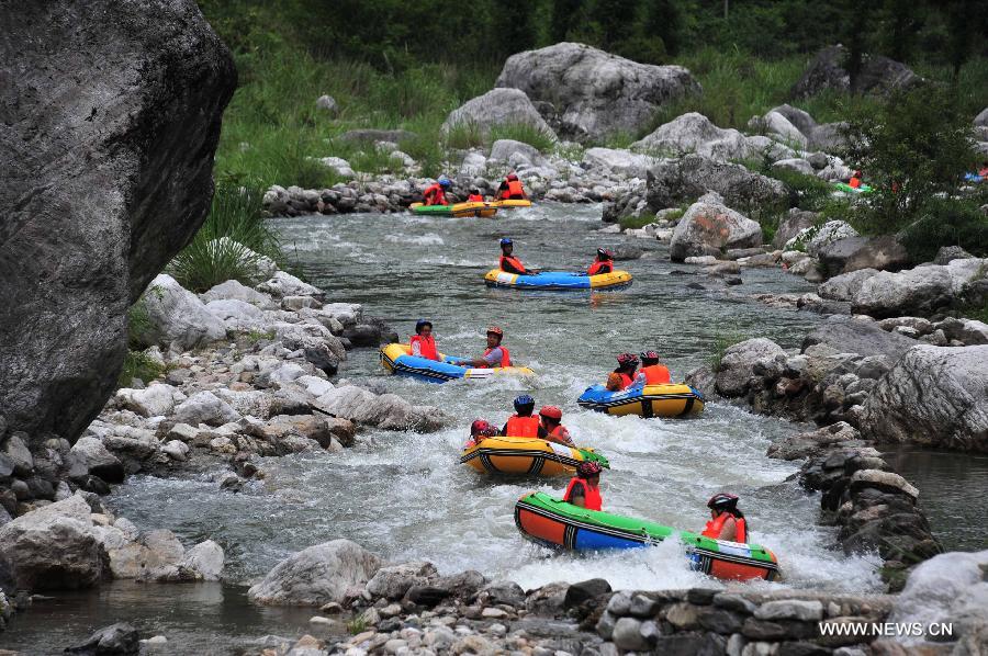 Tourists enjoy rafting in C China