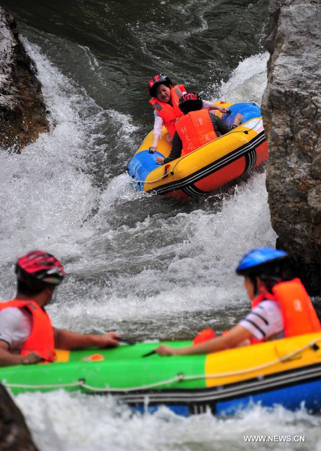 Tourists enjoy rafting in C China