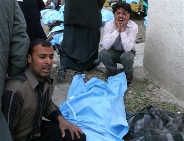 Relatives grieve over lost loved ones at al-Kindi hospital in Baghdad, Iraq, Monday Jan. 22, 2007. Two nearly simultaneous bombs struck a predominantly Shiite commercial area in central Baghdad, killing at least 78 people and wounding at least 156, said Deputy Health Minister Hakim al-Zamili. (AP