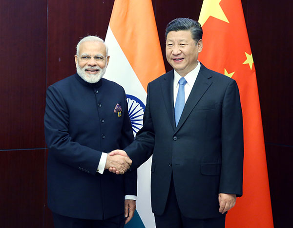 Xi, Modi vow close cooperation