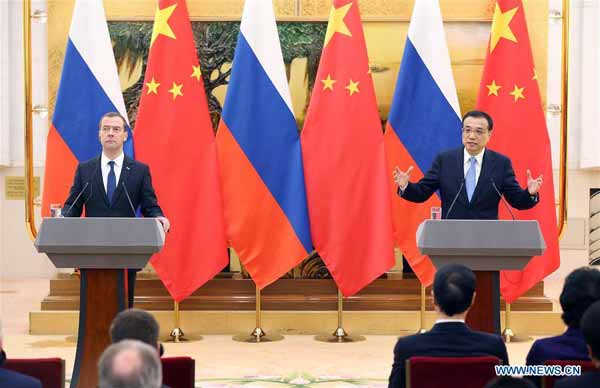 China, Russia sign over 30 deals during Medvedev visit